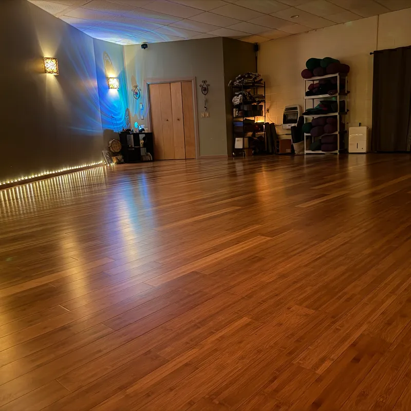 Bamboo floors and glowing string lights inside the studio